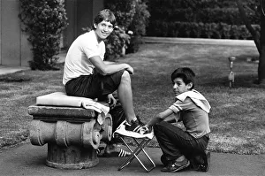 Relaxation Prints: England footballer Gary Lineker has his boots cleaned by a shoe shine boy at the team