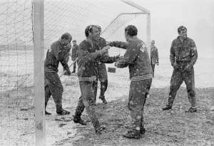 Winter Prints: England footballer Jimmy Greaves laughs as he walks out the goal during a snow covered
