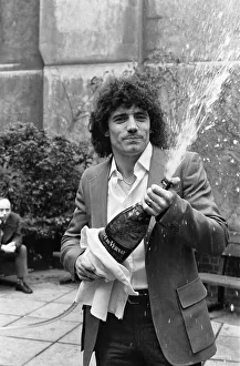 01052 Prints: England footballer Kevin Keegan poses for photographers holding a large champagne bottle
