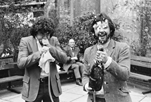 England footballer Kevin Keegan poses for photographers holding a large champagne bottle
