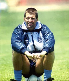 Shellsuit Prints: England footballer Steve Bull sitting on a football as he takes a break from training