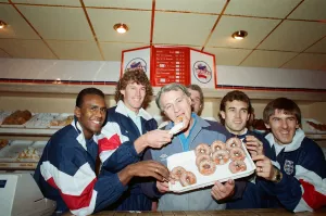 England manager Bobby Robson enjoying a selection of doughnuts with members of his