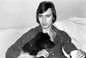00250 Prints: England and Stoke international hero Alan Hudson seen here with his pet poodle
