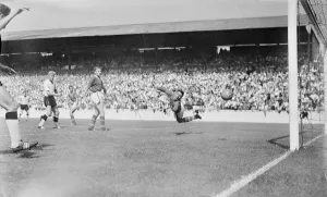 Goal Keeper Prints: English League Division One match. Burgin the Leeds goalie turns in mid air to see