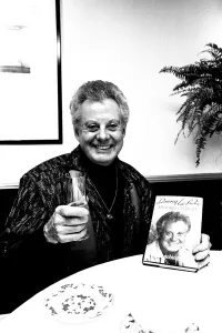 Entertainer Danny La Rue at a Newcastle restaurant signing copies of his autobiography