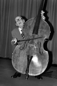 Entertainment. Music. Arthur A. Askey playing the cello. February 1981 81-00677-001