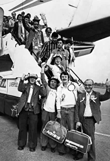 Admiral Prints: Enthusiastic Liverpool fans arrive back at Speke Airport from Rome after watching their