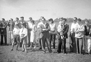 Enthusiasts gather at the edge of the pitch waiting for the game of Motoball