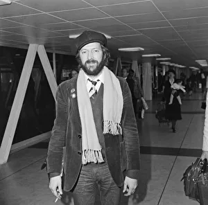 Beret Prints: Eric Clapton pictured leaving Heathrow airport for California