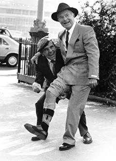 Ernie Wise with Noman Wisdom showing off his legs at the International Men