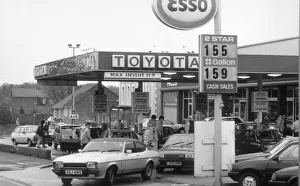 Petrol Prints: Esso Petrol Station with cars filling up and Ford Capri leaving. 2nd March 1986