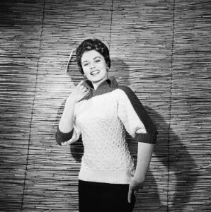 01187 Prints: Eunice Gayson, actress and model, poses in a sweater for Sunday Mirror Promotion