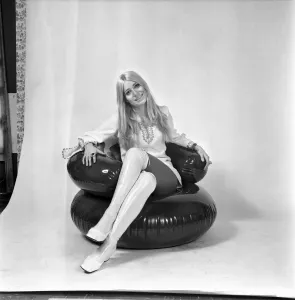 Eva Haraldsted, ex-girl friend of soccer star George Best in a white party dress trimmed