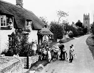 Gifts Prints: Evacuee children in Isle Abbott Village surround the local postman Bertie Adams hoping