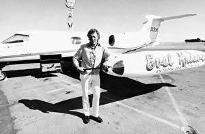 Jon Scan Prints: Evel Knievel American stuntman daredevil 1974 in front of his personal plane
