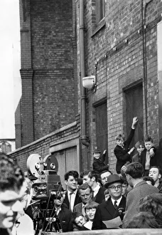 Everton chairman Mr. John Moores is besieged as he leaves Goodison Park
