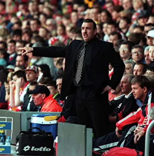 Everton goalkeeper Neville Southall catches the ball with Eric Cantona jumping Manchester