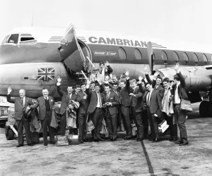 00350 Prints: Everton team members wave before their plane bound for Australia departs from Speke