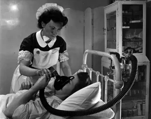 Childbirth Prints: An expectant mother using an inhaler to take the pain killing drug trilene during labour