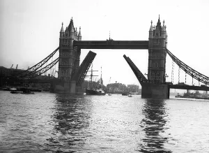 The expedition ship Sir E Shackleton sails through the open roadway of Tower Bridge into
