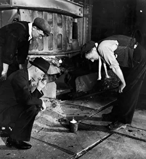 An expert makes a closer examination of a sample of steel taken from a 30 ton Electric