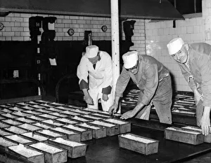 Bakery Prints: Export Dundee cakes are loaded onto the oven trays in the Avana Bakery, Cardiff
