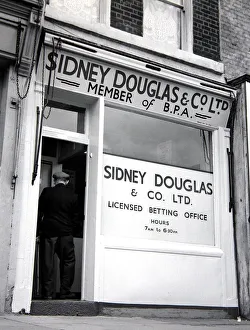 00170 Prints: An exterior view of Sidney Douglas betting shop in Mile End Road London May 1961
