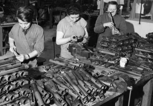 Munitions Prints: A factory doing vital work on the sten gun for the Ministry of Supply employs workers of