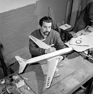 Factory where model aircraft for the travel agents are made. Men making model planes