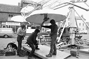 Fairground workers assembly a ride in Stokesley in preparation of the annual fair