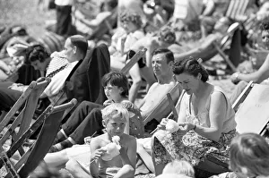 Holidaymaker Prints: Families enjoying the summer sun and candy floss on the beach at Southend, Essex