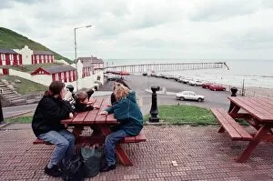 00686 Collection: Families sitting on a bench looking at Saltburn pier, North Yorkshire. 9th May 1996
