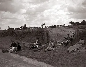 A family of cyclists enjoying a break from their journey into the countryside