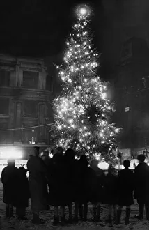 A family group admire the lit Christmas Tree in Church Street after a fresh fall of snow