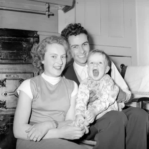 00065 Prints: Family Life: Mr. and Mrs. Hull seen here with their son listening to the radio on their