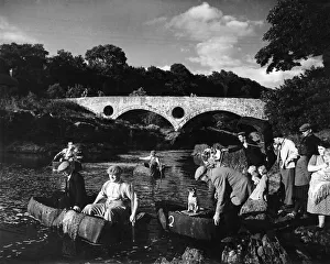 00505 Prints: By the famous Cenarth bridge the coracle fishers set out for a days fishing