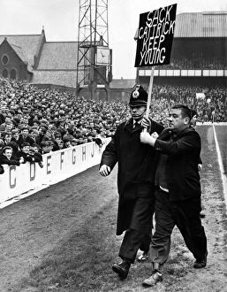 Images Dated 20th July 2021: A fan being escorted off the football pitch by a policeman