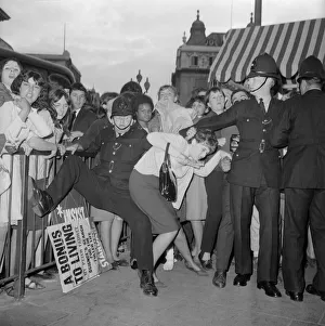 Beatlemania Prints: Fans of The Beatles pop group at Piccadilly Circus battle with police as they try to get