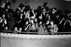 fans of British pop group The Thompson Twins watch them performing on stage during a