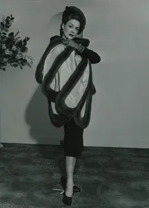 Cloak Prints: Fashion 1950s Model wearing a wild mink stole on pleated taffeta with matching gloves