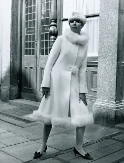 Fashion 1960s Model standing outside Carrot on Wheels boutique wearing a mid-calf