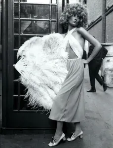 Fashion 1960s Model standing by a telephone box in London in a Gangter