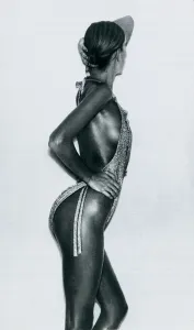 Fashion 1970s Model wearing a gold lurex swimsuit by Coveri for Tauche October 1976
