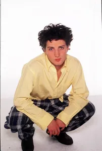 00493 Prints: Fashion - Model Kate Moss brother Nick crouching wearing tartan style trousers