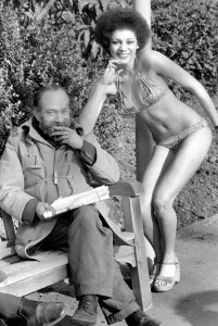 Afro Prints: Fashion scene from Woolworth s. An old man sitting on a park bench reading his