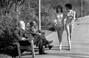 Fashion scene from Woolworth s. Two old men sitting on a park bench distracted by