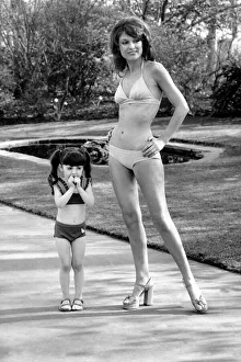 Fashion scene from Woolworth s. Woman wearing a bikini standing in the park with a