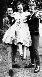 Fashion Teddy Boys Youth Tina Handy is lifted upby two teddy boys one of whom she