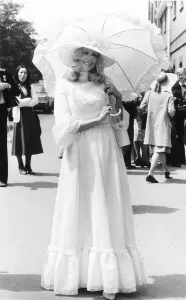 Fashionable racegoer with parasol at Royal Ascot in 1977 Seventies fashion