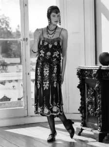 Fashions 1920 s: Beaded flapper dress and skull cap with neat T-bar shoes